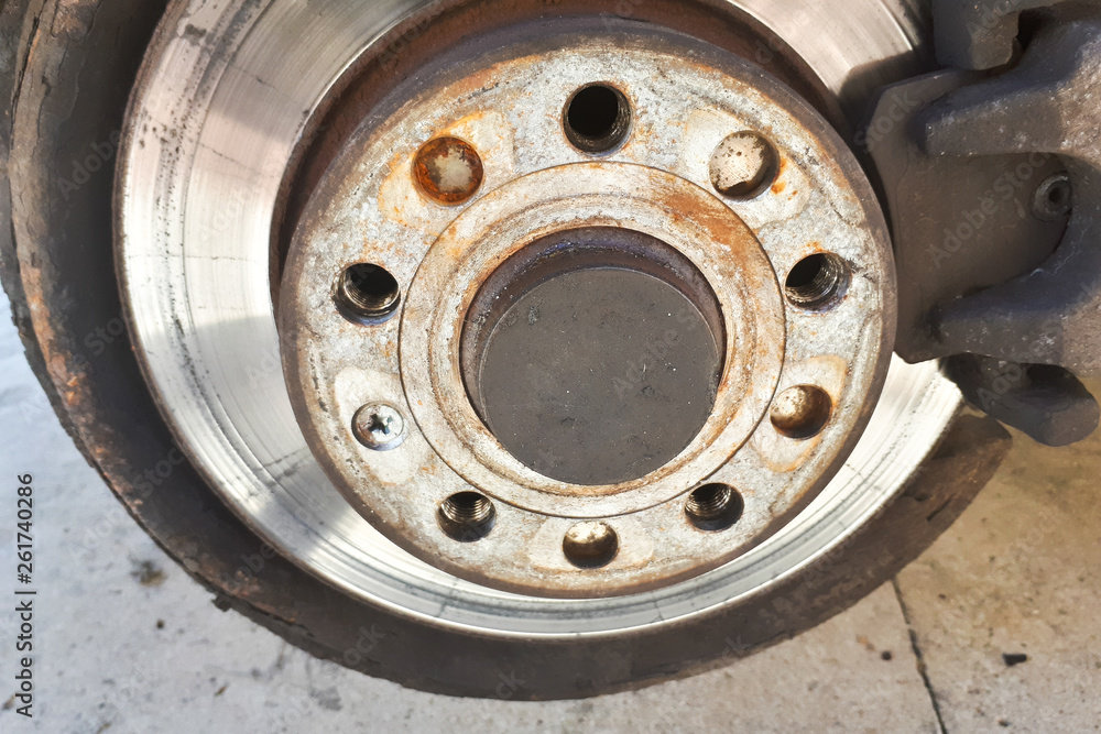 Closeup disc brake of the vehicle for repair. Detail image of car brakes. Closeup disc brake of the vehicle for repair. Detail image of car brakes.
