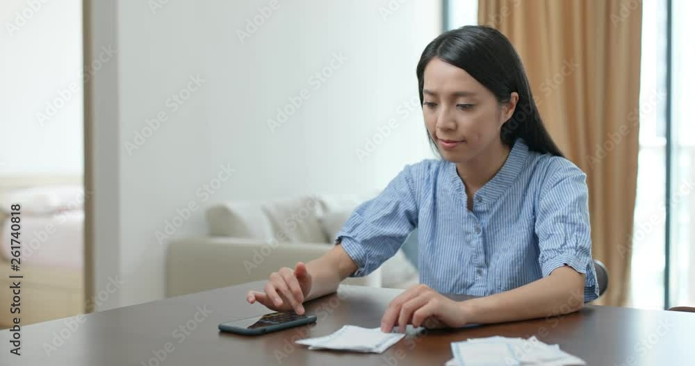 Housewife calculate the credit card bill at home Housewife calculate the credit card bill at home