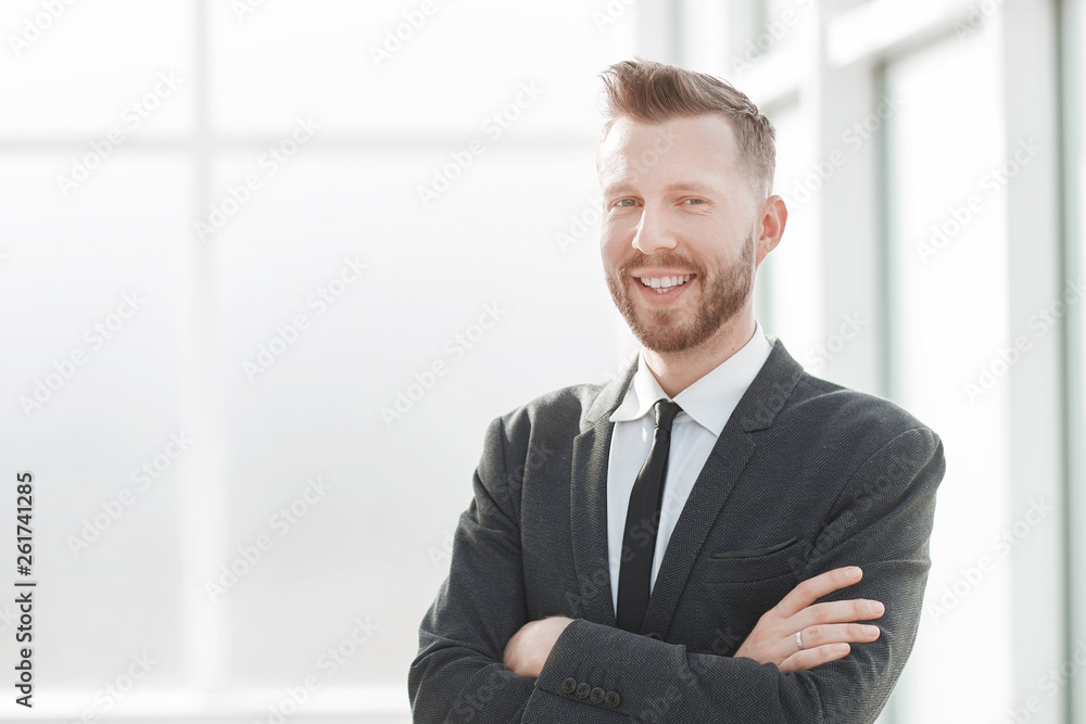 successful businessman on the background of a bright office. successful businessman on the background of a bright office.