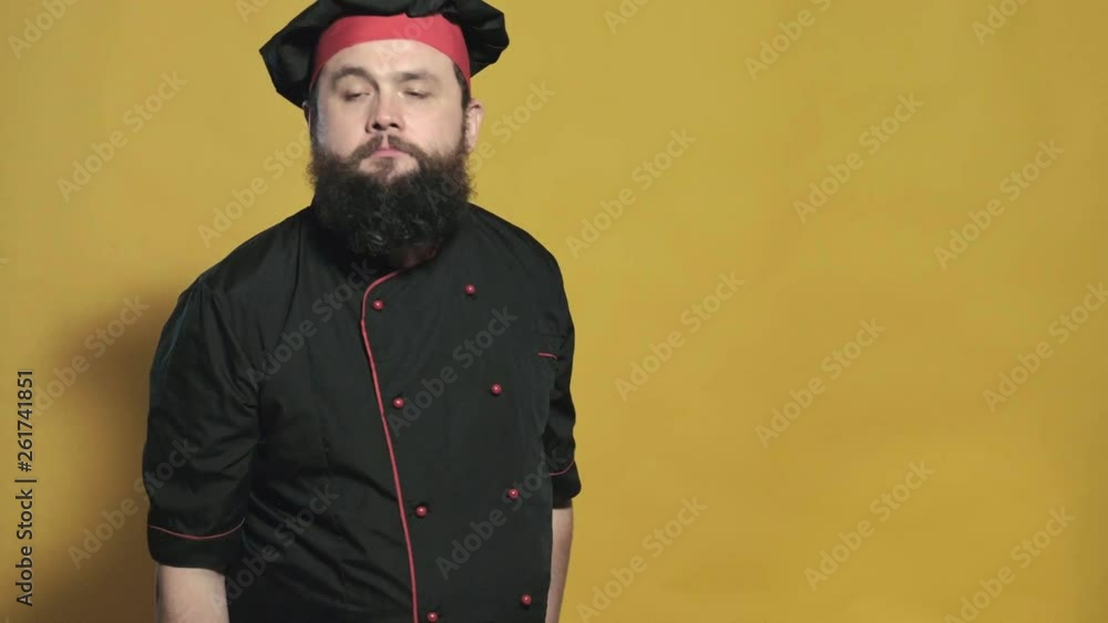 cook in a black suit on a yellow background cook in a black suit on a yellow background