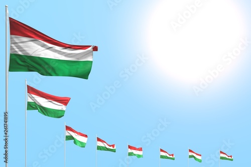 nice many Hungary flags placed diagonal on blue sky with space for text - any celebration flag 3d illustration..