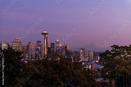 Sunset over the skyline of the city of Seattle and the profile of Mount Rainier in the background.