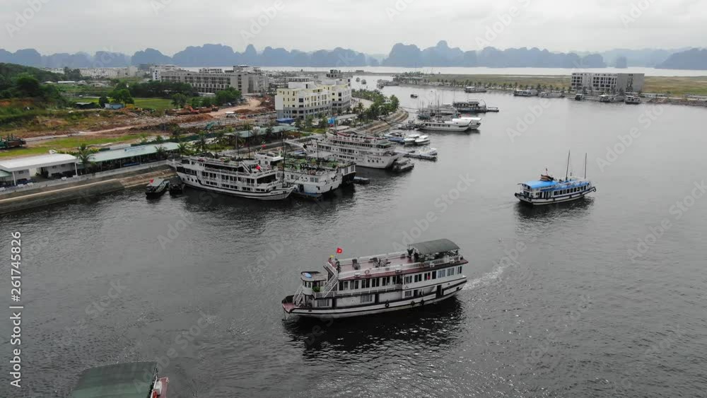 A smooth and peaceful view of boats travelling along the terminal pier of Tuan Chau,Vietnam A smooth and peaceful view of boats travelling along the terminal pier of Tuan Chau,Vietnam