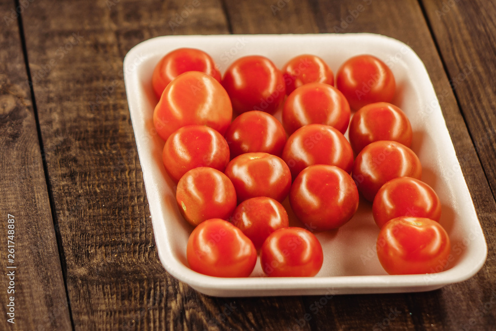tasty cherry tomatoes on a wooden stand, wooden background Stock Photo