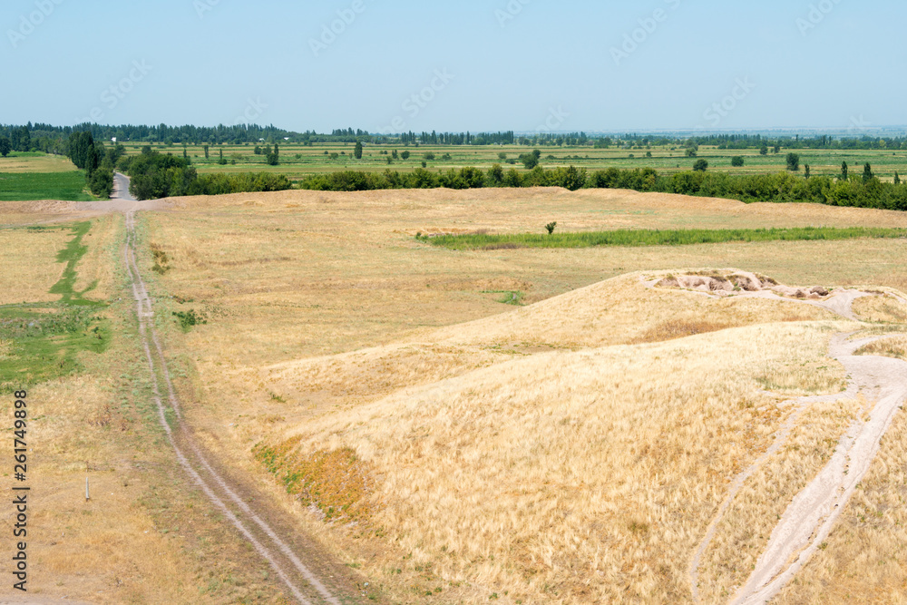 Tokmok, Kyrgyzstan - Aug 08 2018: Ruins of Balasagun in Tokmok, Kyrgyzstan. Balasagun is part of the World Heritage Site-Silk Roads: the Routes Network of Chang'an-Tianshan Corridor. Tokmok, Kyrgyzstan - Aug 08 2018: Ruins of Balasagun in Tokmok, Kyrgyzstan. Balasagun is part of the World Heritage Site-Silk Roads: the Routes Network of Chang'an-Tianshan Corridor.
