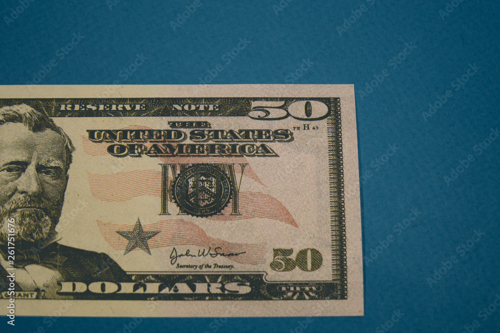isolated american fifty dollar bill on blue background isolated american fifty dollar bill on blue background