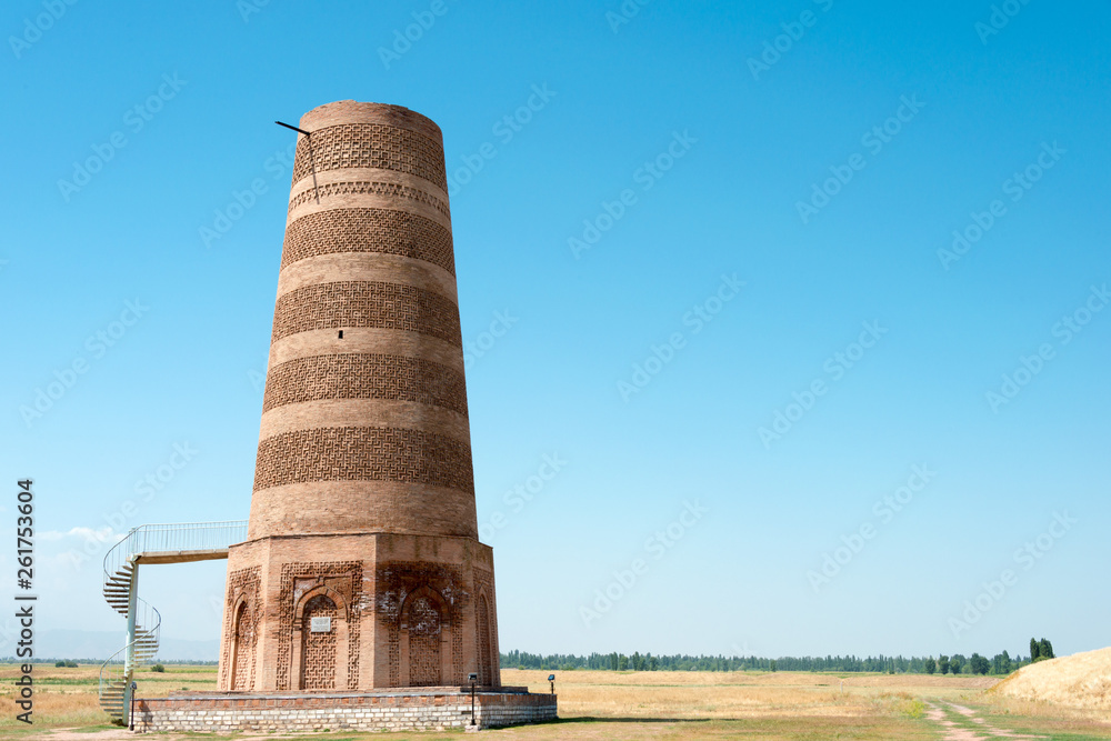 Tokmok, Kyrgyzstan - Aug 08 2018: Ruins of Burana Tower in Tokmok, Kyrgyzstan. It is part of the World Heritage Site - Silk Roads: the Routes Network of Chang'an-Tianshan Corridor. Tokmok, Kyrgyzstan - Aug 08 2018: Ruins of Burana Tower in Tokmok, Kyrgyzstan. It is part of the World Heritage Site - Silk Roads: the Routes Network of Chang'an-Tianshan Corridor.