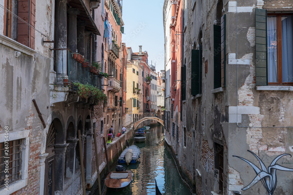 Panoramic view of Venice narrow canal with historical buildings and boat