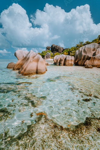 Anse Source d'Argent - Dreamlike, paradise beach with unique bizarre granite boulders, shallow lagoon water. La Digue island, Seychelles. Vertical shot