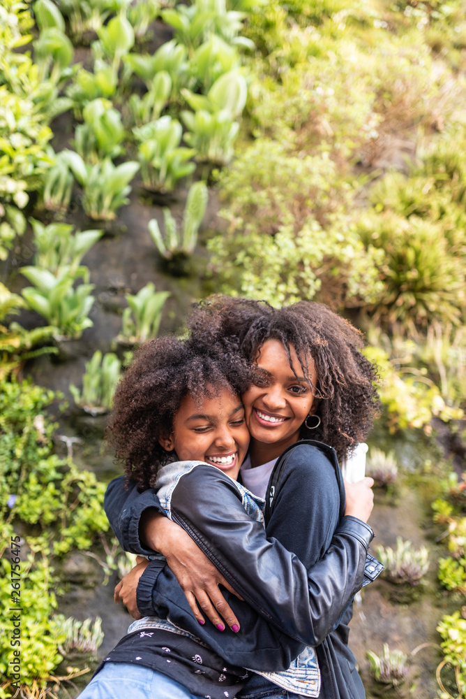 Afro American Mother and Daughter Hugging to Each Other.