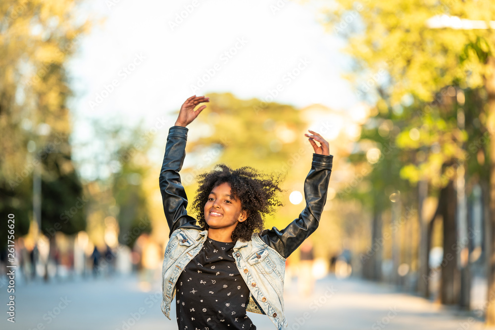 Cute Afro American Teenager Jumping Outdoors.