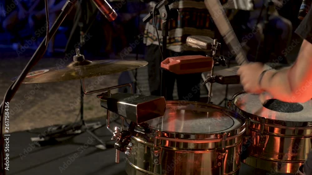 Close up musician drummer playing percussion on drum during live music performance. Close up musician drummer playing percussion on drum during live music performance.