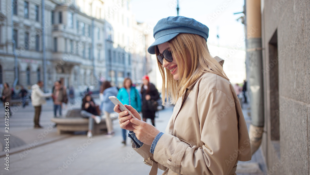 Cute fashionable girl uses apps in phone, shopping and banking Cute fashionable girl uses apps in phone, shopping and banking
