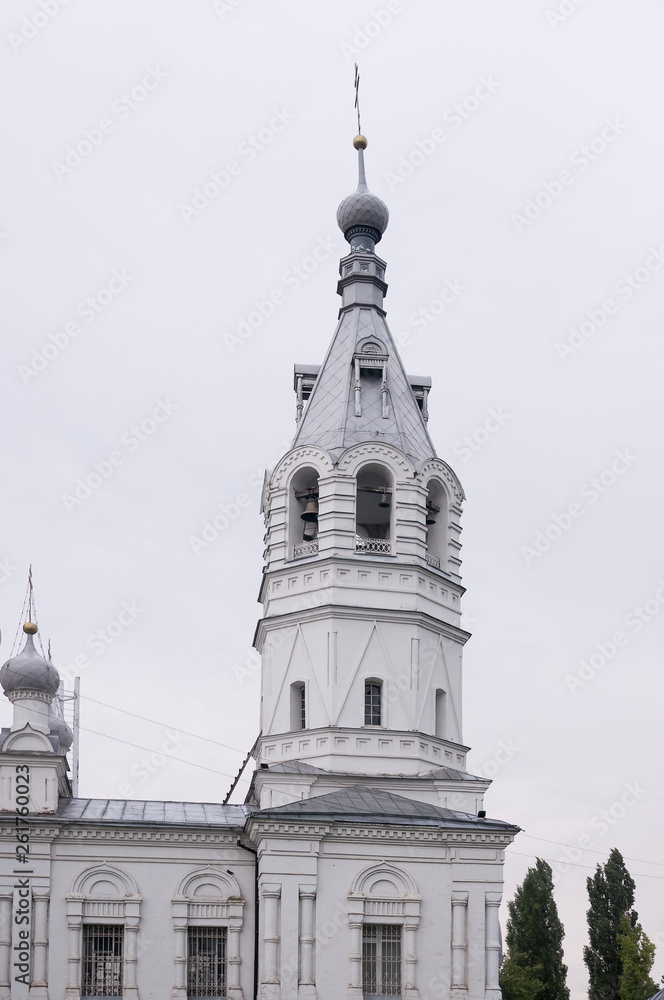 Obraz premium Christian orthodox white church with silver and grey domes with gold crosses. Calm grey sky above