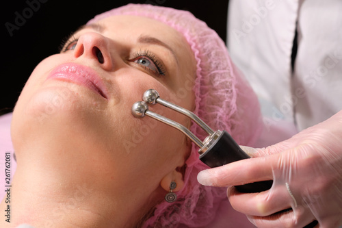 Cosmetologist making hardware procedures for the face  to her patient  . Anti-ageing and smoothing procedure in a beauty salon. Doctor in a cosmetological clinic making a treatment of skin care