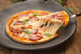 Close-up of pizza. Warm background and wood.