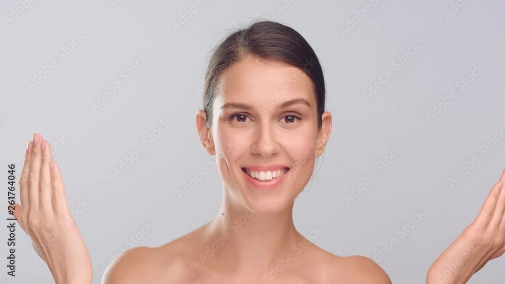 Young woman opens her eyes, closed with palms and smiling Young woman opens her eyes, closed with palms and smiling
