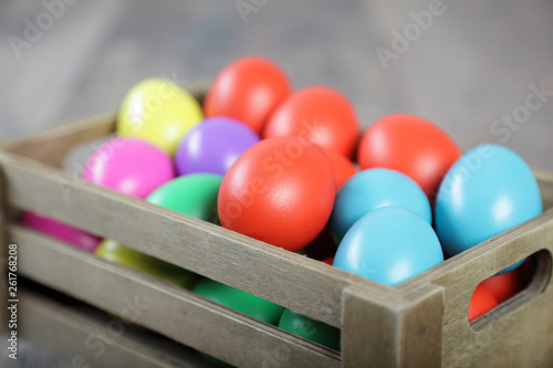 Multicoloured Easter eggs in a wooden box