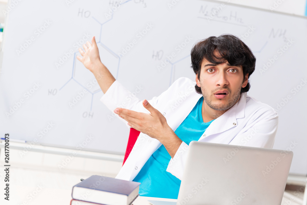Young student chemist in the classroom Young student chemist in the classroom