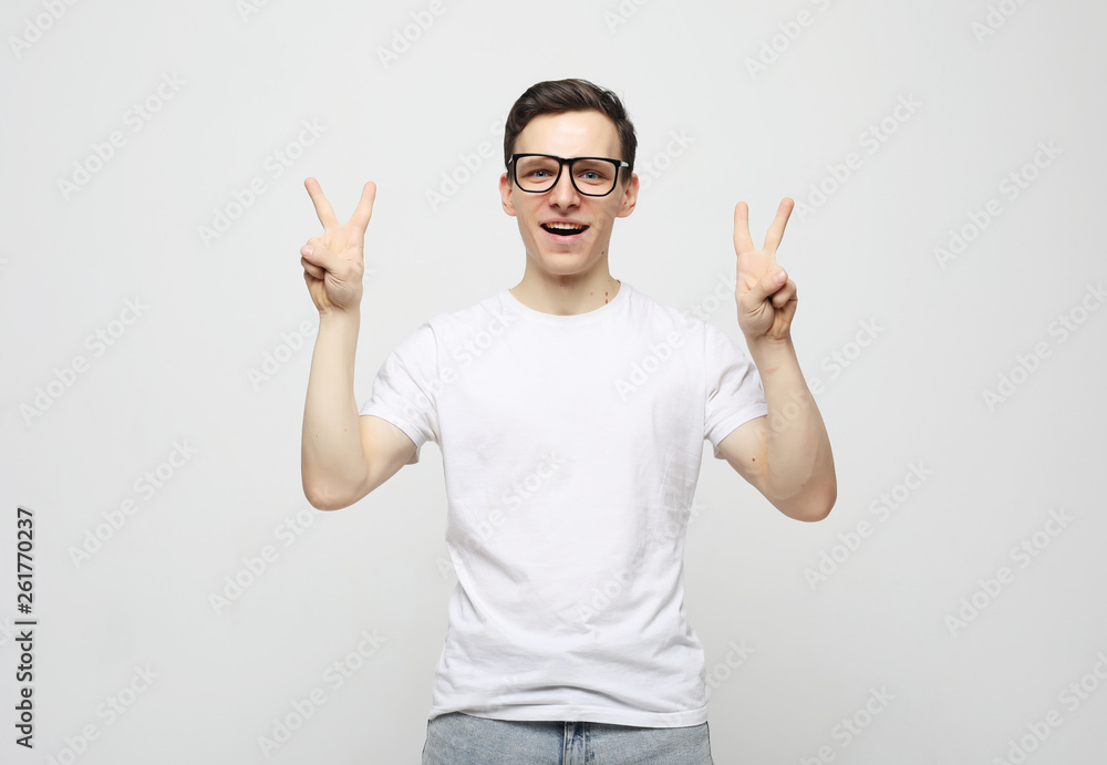 man showing fingers doing victory sign man showing fingers doing victory sign