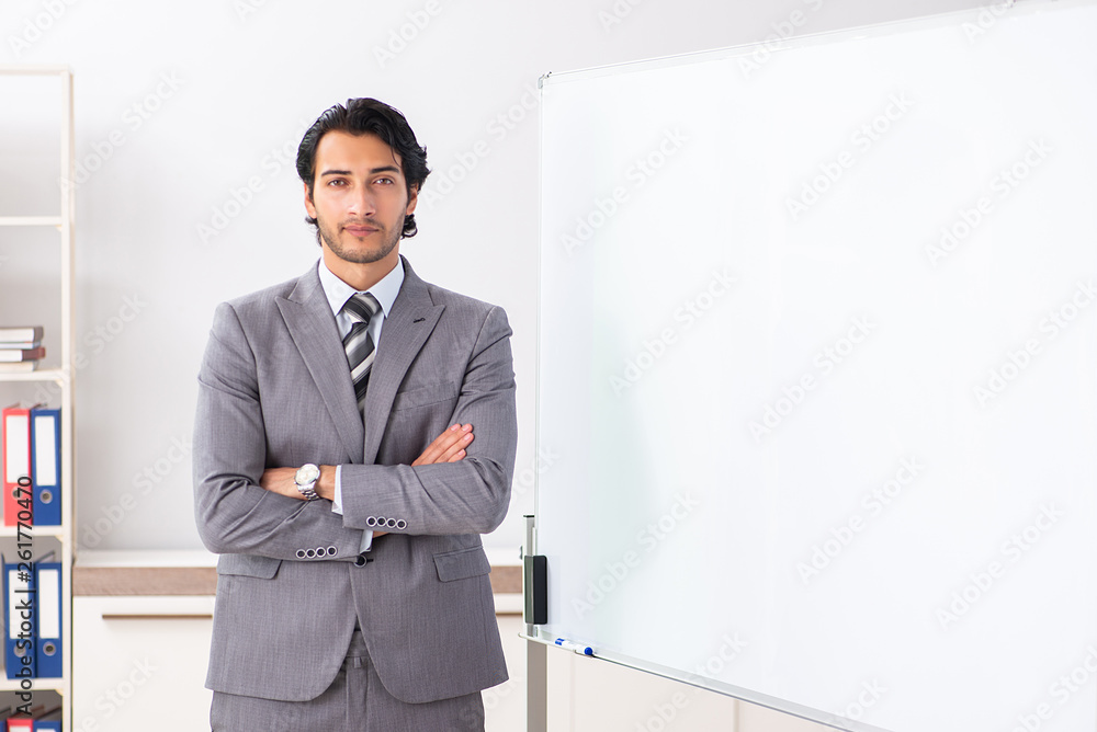 Young handsome businessman in front of whiteboard Young handsome businessman in front of whiteboard