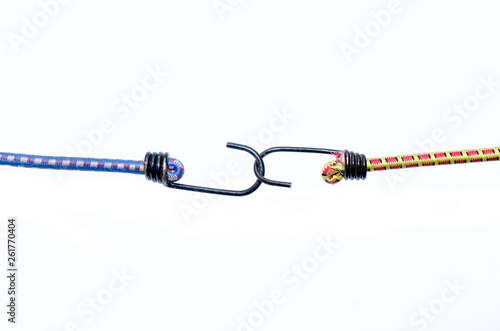 Fotografia Two elasticated bungee cords linked together with the metal hooks affixed to the end isolated on white