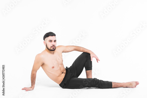 Handsome model man posing to the camera wearing at black pants!