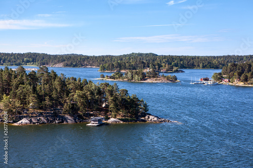 Rugged nature with wooded islands and rocky cliffs in Stockholm archipelago. Uninhabited islets  communities and ancient villages with houses and small cottages. Sweden