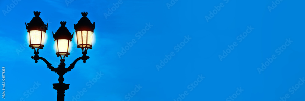 Illuminated street light at night, blue sky panoramic background, Paris, France Illuminated street light at night, blue sky panoramic background, Paris, France