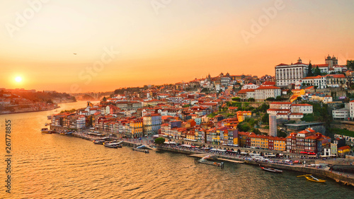 Beautiful skyline of portuguese city Porto taken during amazing sunset. Captured on 16:9 picture. The city center and the Porto Cathedral are in orange sunset light. © ppohudka