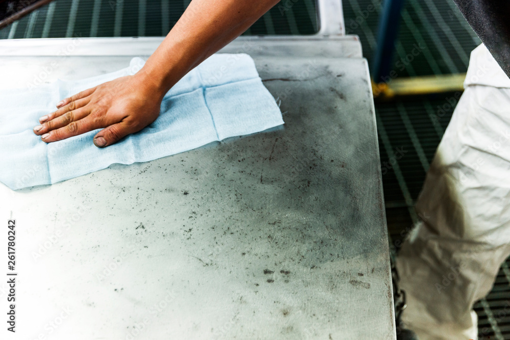 Clean & polishing steel car door surface with blue cloth. Clean & polishing steel car door surface with blue cloth.
