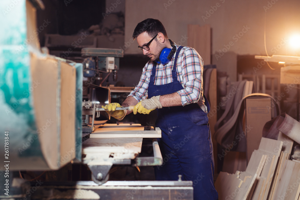 Carpenter doing his job in carpentry workshop Carpenter doing his job in carpentry workshop