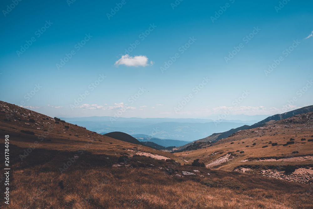 Fototapeta premium A landscape with a lake and beautiful clouds and rocks.
