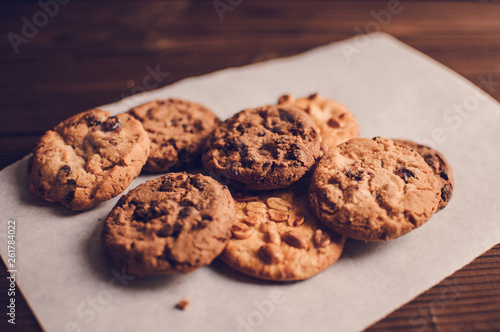 Stack of Chocolate chip cookies on wooden background.