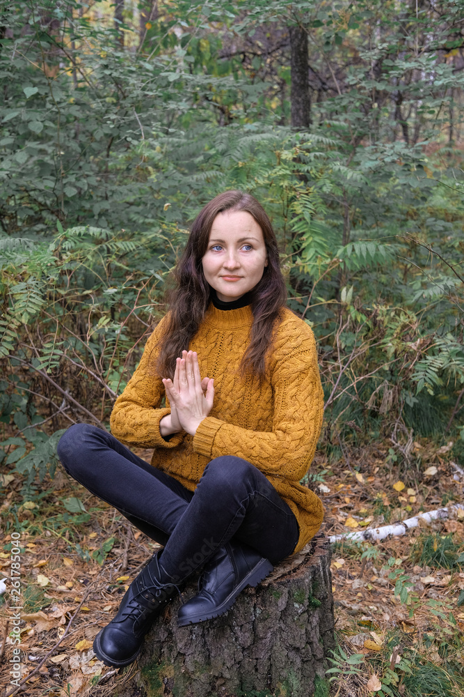 Female model doing yoga in the autumn forest. Female model doing yoga in the autumn forest.