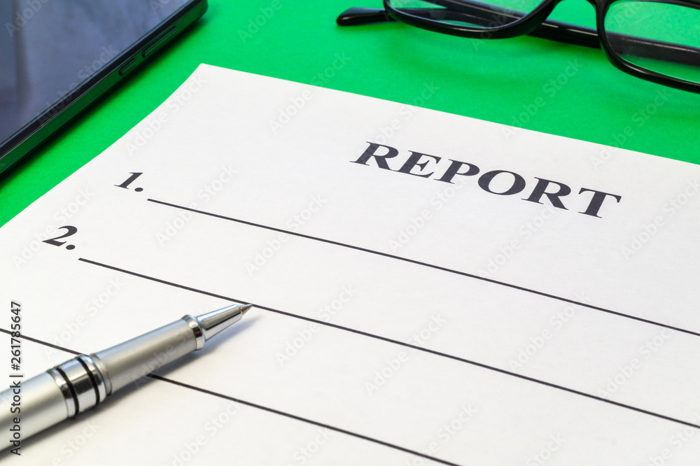Report with pen and smartphone on green table. Report with pen and smartphone on green table.