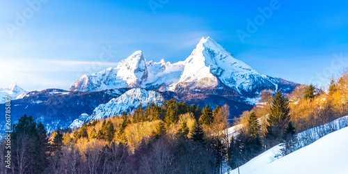 Beautiful winter wonderland mountain scenery in the Alps with pilgrimage church of Maria Gern and famous Watzmann summit in the background, Berchtesgadener, Bavaria, Germany