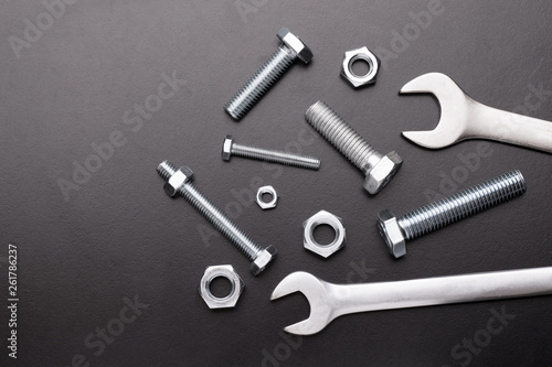 Steel Nuts and Bolts. Nuts and wrench bolts on a dark background.