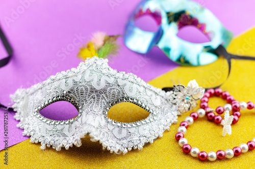 A festive,Beautiful white mardi gras or carnival mask on beautiful colorful paper background