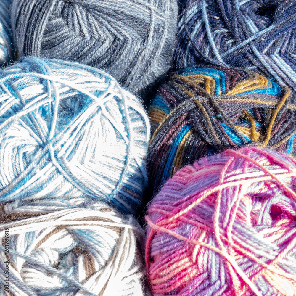 Close-up of colourful balls of wool on the sales stand of a flea market Close-up of colourful balls of wool on the sales stand of a flea market