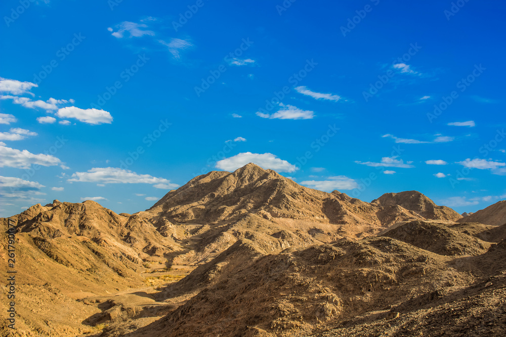 picturesque sand stone wilderness highland bare rocky mountain scenic landscape on vivid blue sky background 