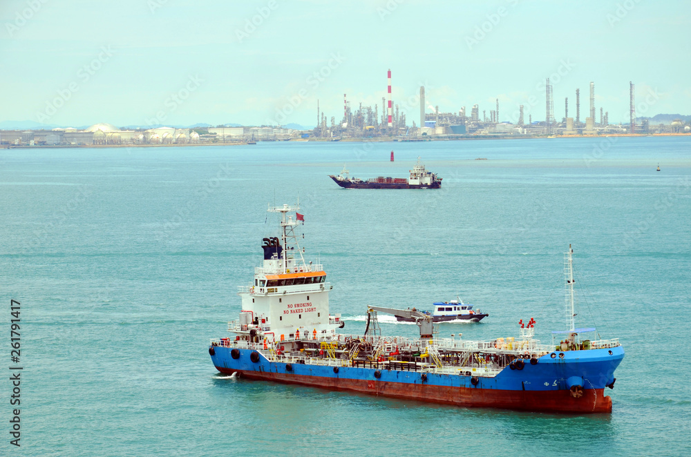 Tanker ship ready to supply fuel to the cargo ship, Singapore industrial areas.
