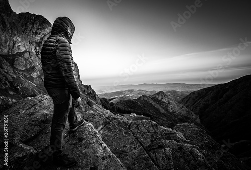 Man hiker on top of mountain peak, extreme, explorer, black and white