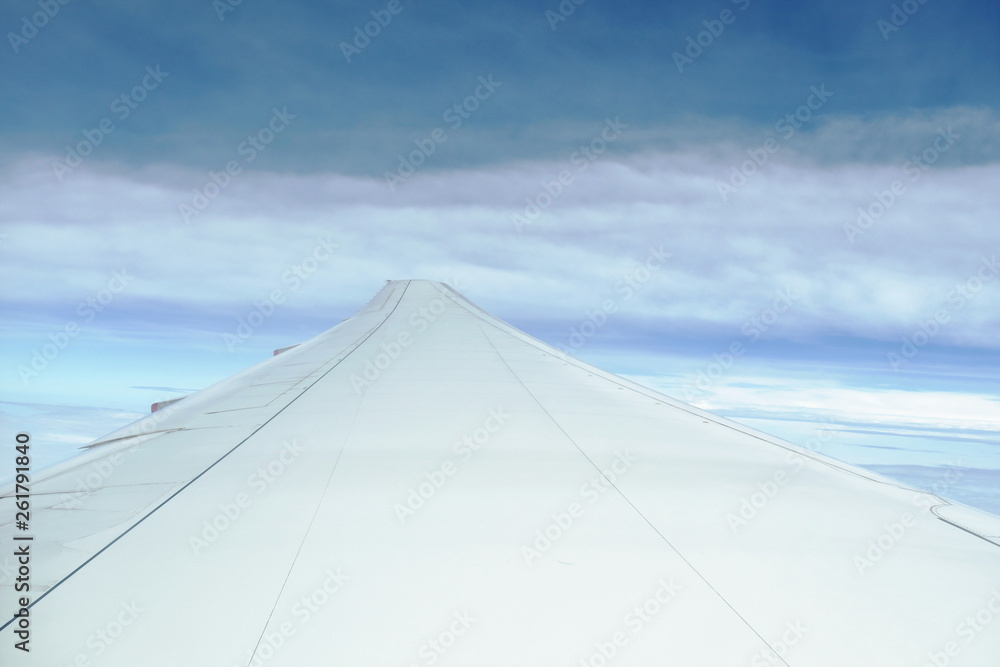 Fototapeta premium plane wing and cloud floating on sky through window frame