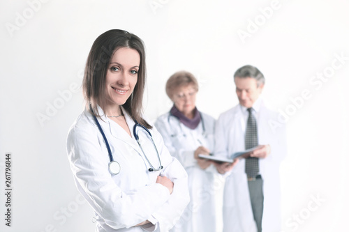 confident female doctor therapist on blurred background of colleagues