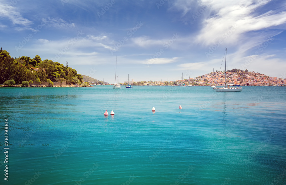 Panoramic view from the sea of Poros island in Aegean sea, Greece. Crystal clear turquoise water