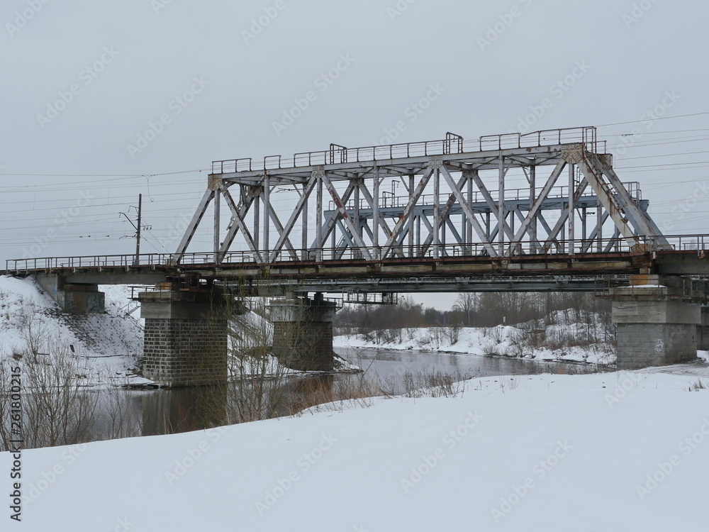 american steel railway bridge over the river winter landscape