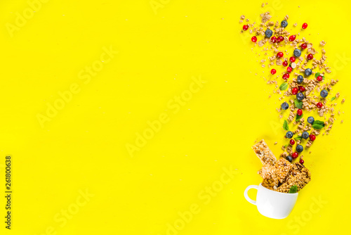 Small cup with breakfast granola, nuts and berries