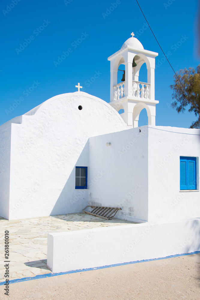 Traditional white church with blue window in Mandrakia fishing village in Milos island, Greece