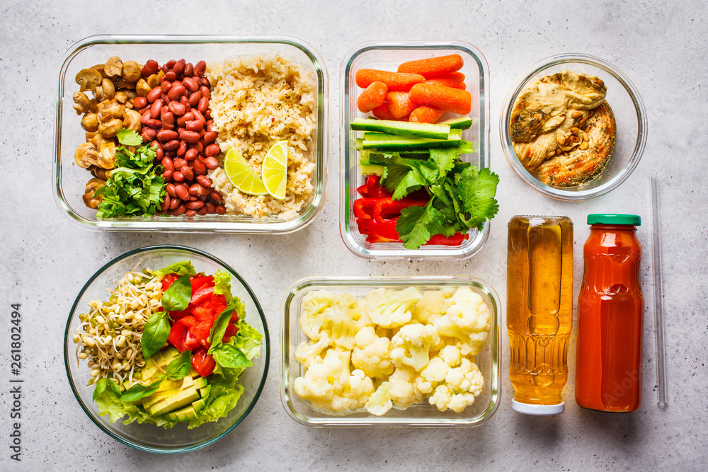 Healthy vegan food in glass containers, top view. Rice, beans, vegetables, hummus and juice. Healthy vegan food in glass containers, top view. Rice, beans, vegetables, hummus and juice.
